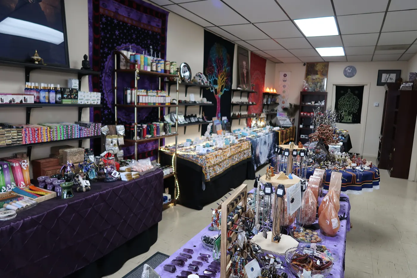Candles, incense and tapestries along the left wall