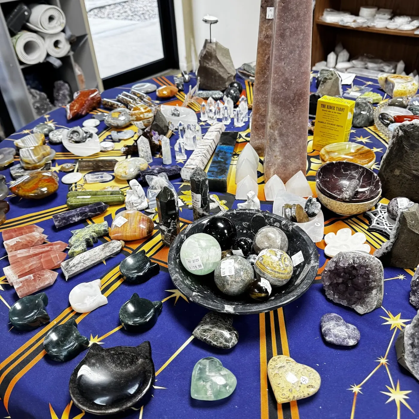 Palm stones, hearts, towers and a bowl of spheres on the zodiac tablecloth
